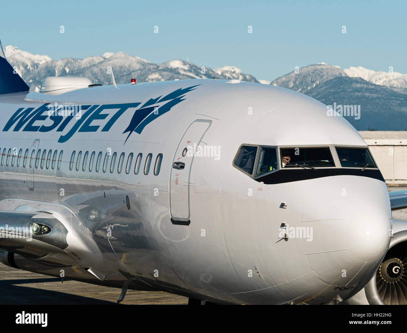 WestJet Airlines plane airplane Boeing 737 (737-700) airliner taxiing along the tarmac, Vancouver International Airport Stock Photo