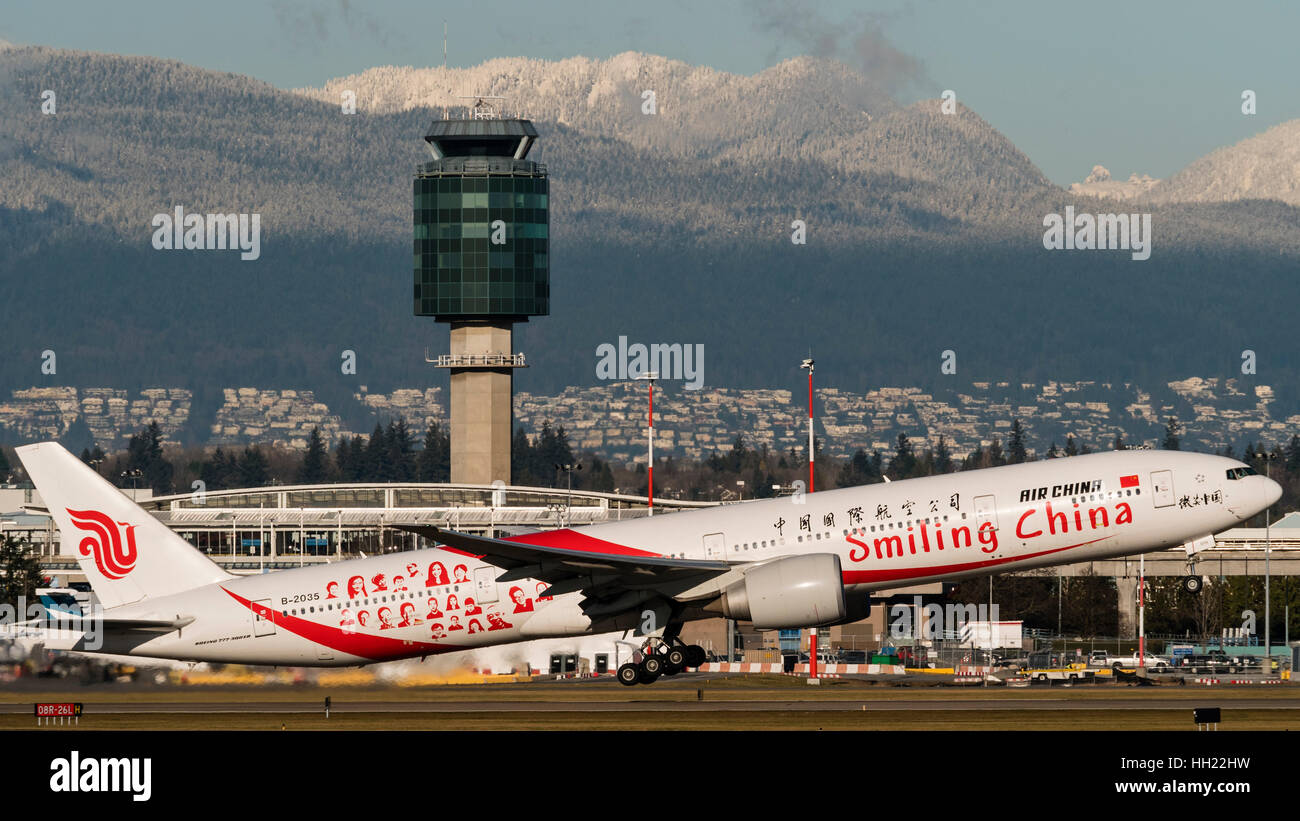 Air China plane airplane Boeing 777 (777-300ER) painted in special 'Smiling China' livery takes taking off Vancouver International Airport Stock Photo