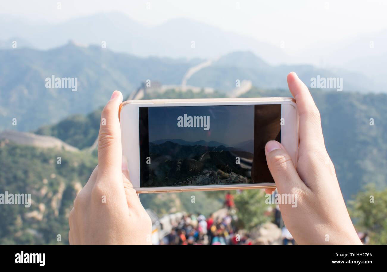 Happy tourist taking picture on the Great Wall of China Stock Photo