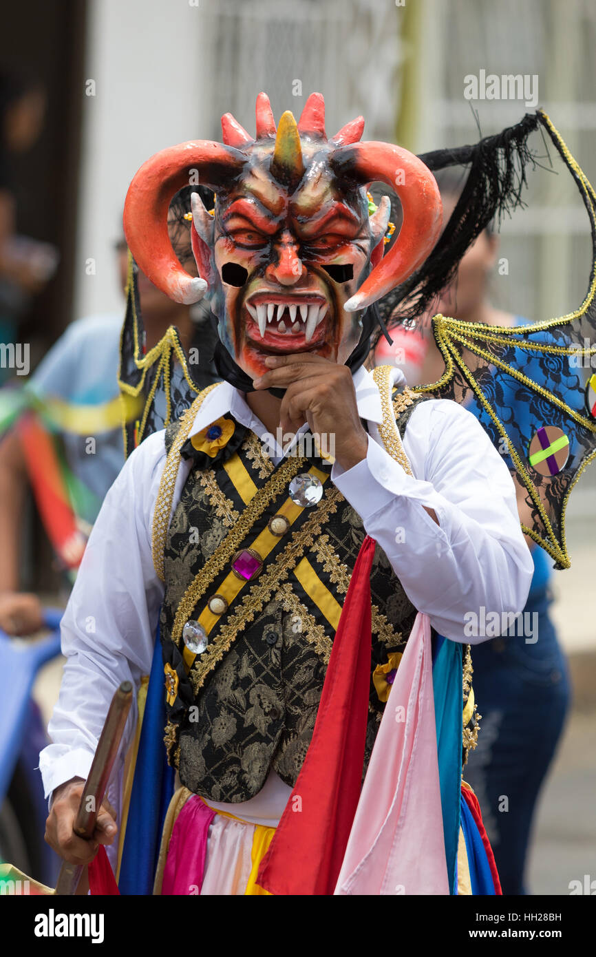 May 25, Los Santos, Panama: man lifts its mask in the scorching heat,  in colorful  clothing during Corpus Cristi celebration Stock Photo
