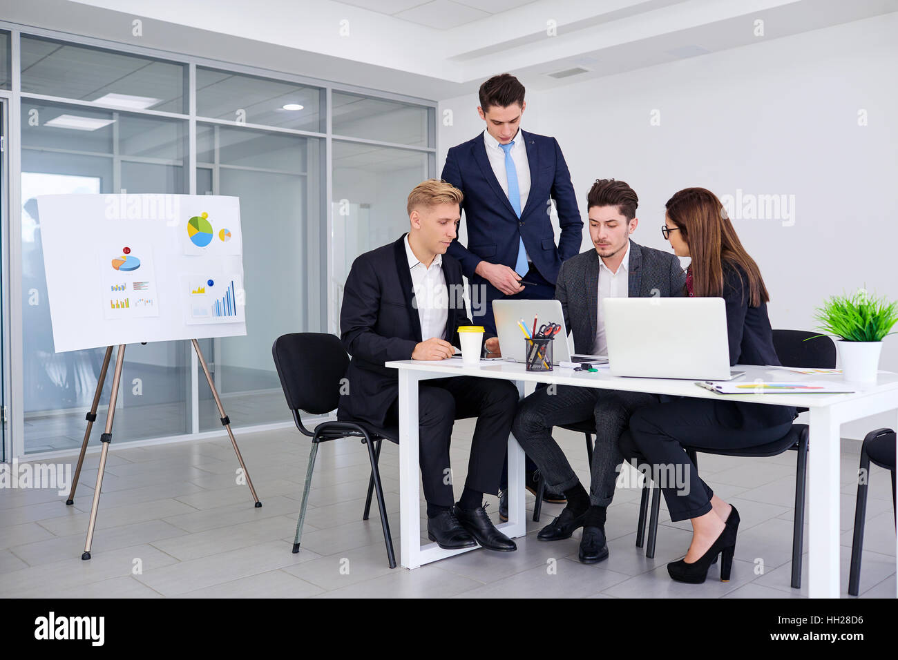 Team of business people work at a desk in modern office Stock Photo - Alamy