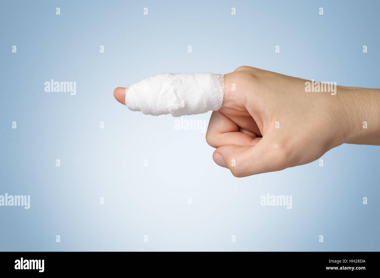 Injured painful finger with white gauze bandage Stock Photo Alamy