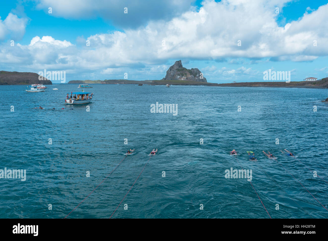 Tourists snorkeling off the Brazilian Atlantic island Fernando de ...
