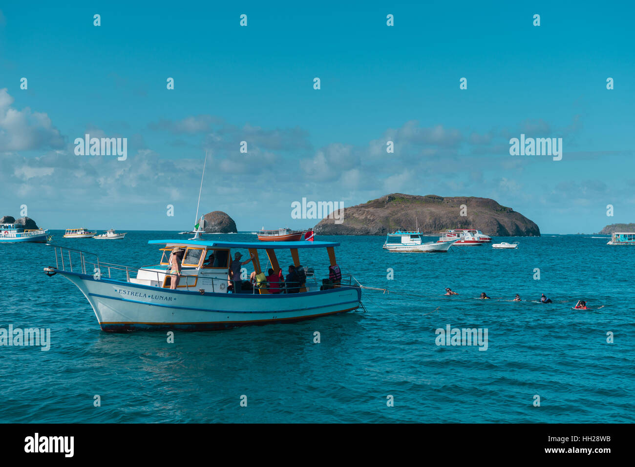 Tourists snorkeling off the Brazilian Atlantic island Fernando de ...
