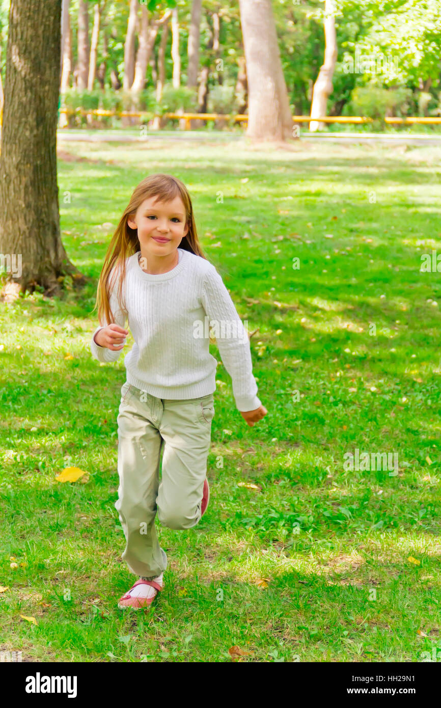 Photo of cute running girl in summer Stock Photo