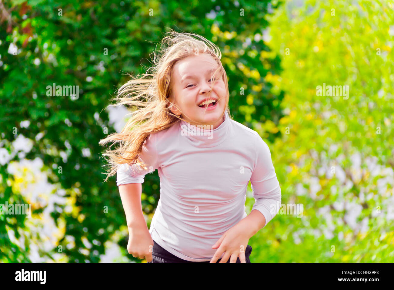 Photo of cute running girl in summer Stock Photo