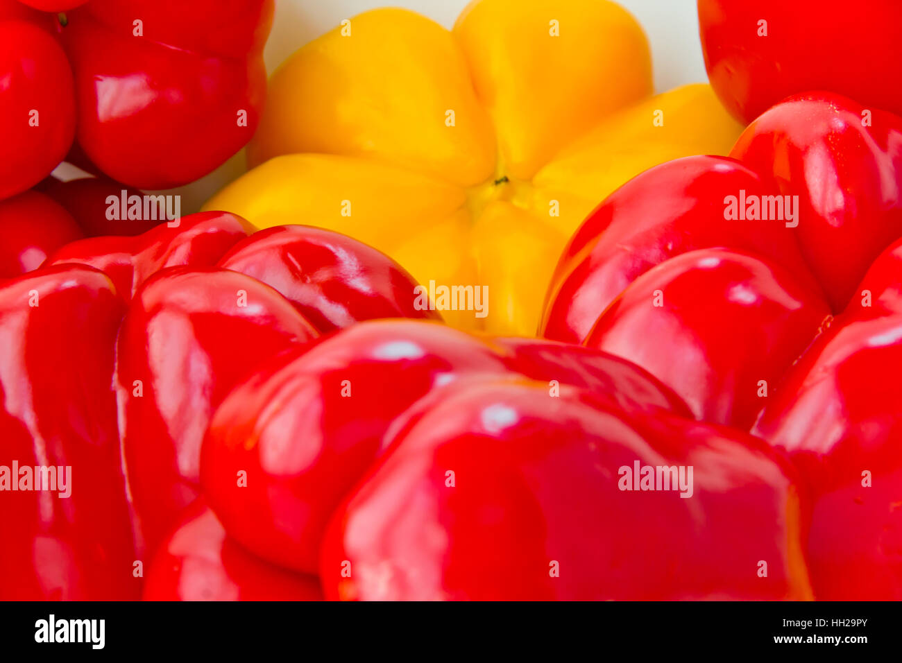 Photo of red and yellow raw pepper on white background Stock Photo - Alamy