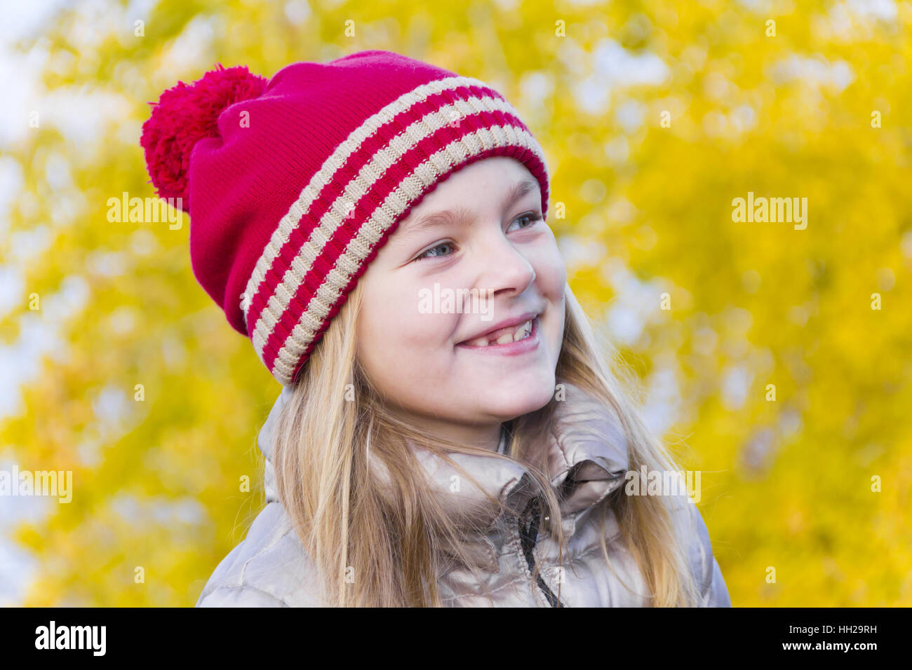 Portrait of cute smiling girl in red hat Stock Photo - Alamy