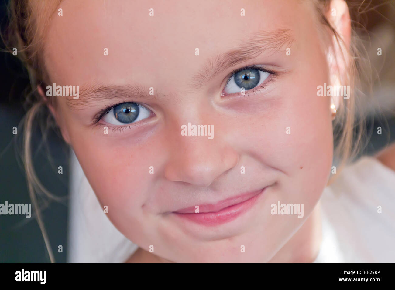 Cute girl with blond long hair and blue eyes Stock Photo - Alamy