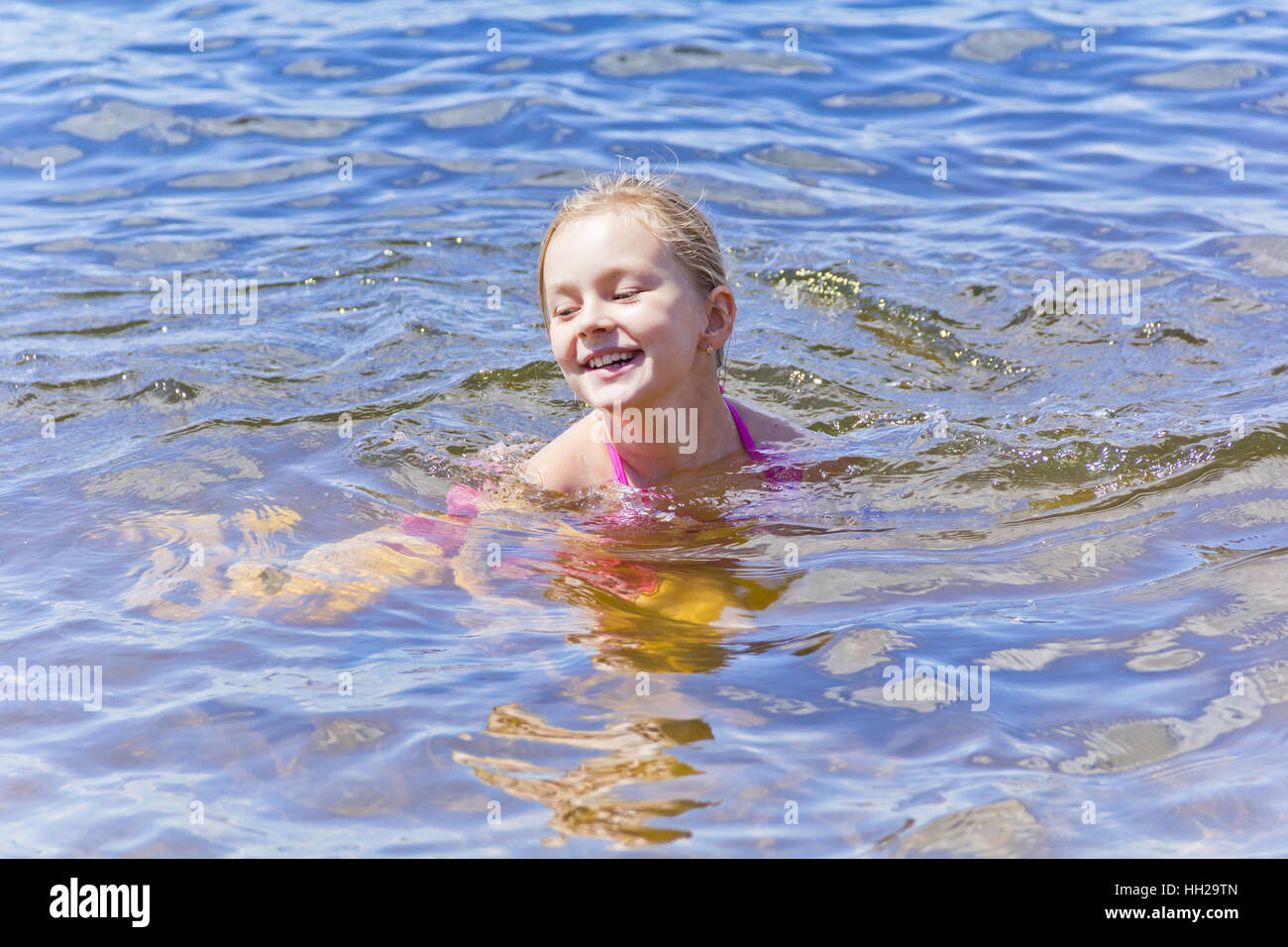 Swimming smiling cute girl seven years old Stock Photo