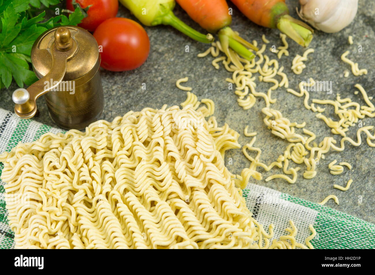 square of uncooked noodles with carrots and parsley Stock Photo
