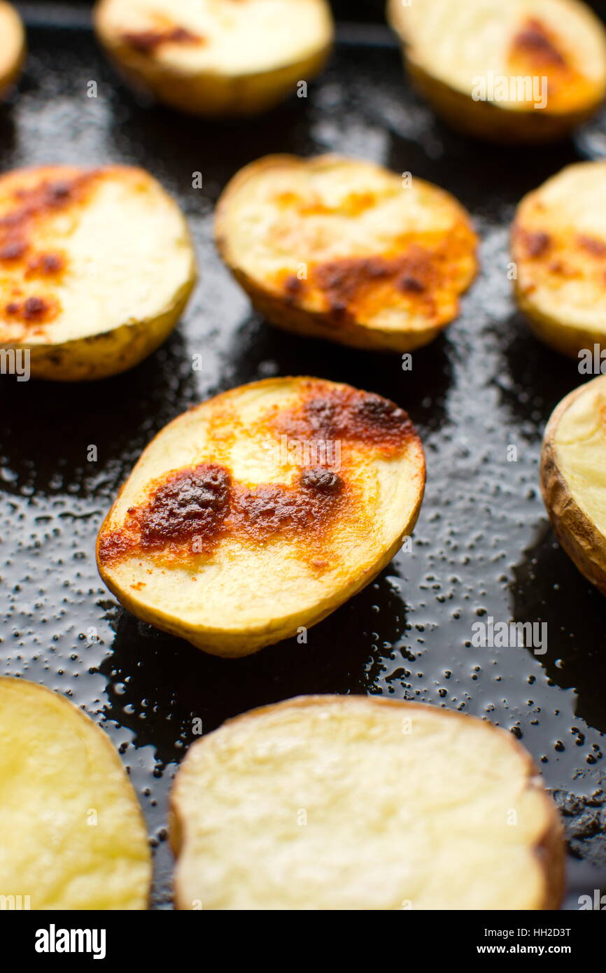 Baked potato on a black baking plate Stock Photo Alamy