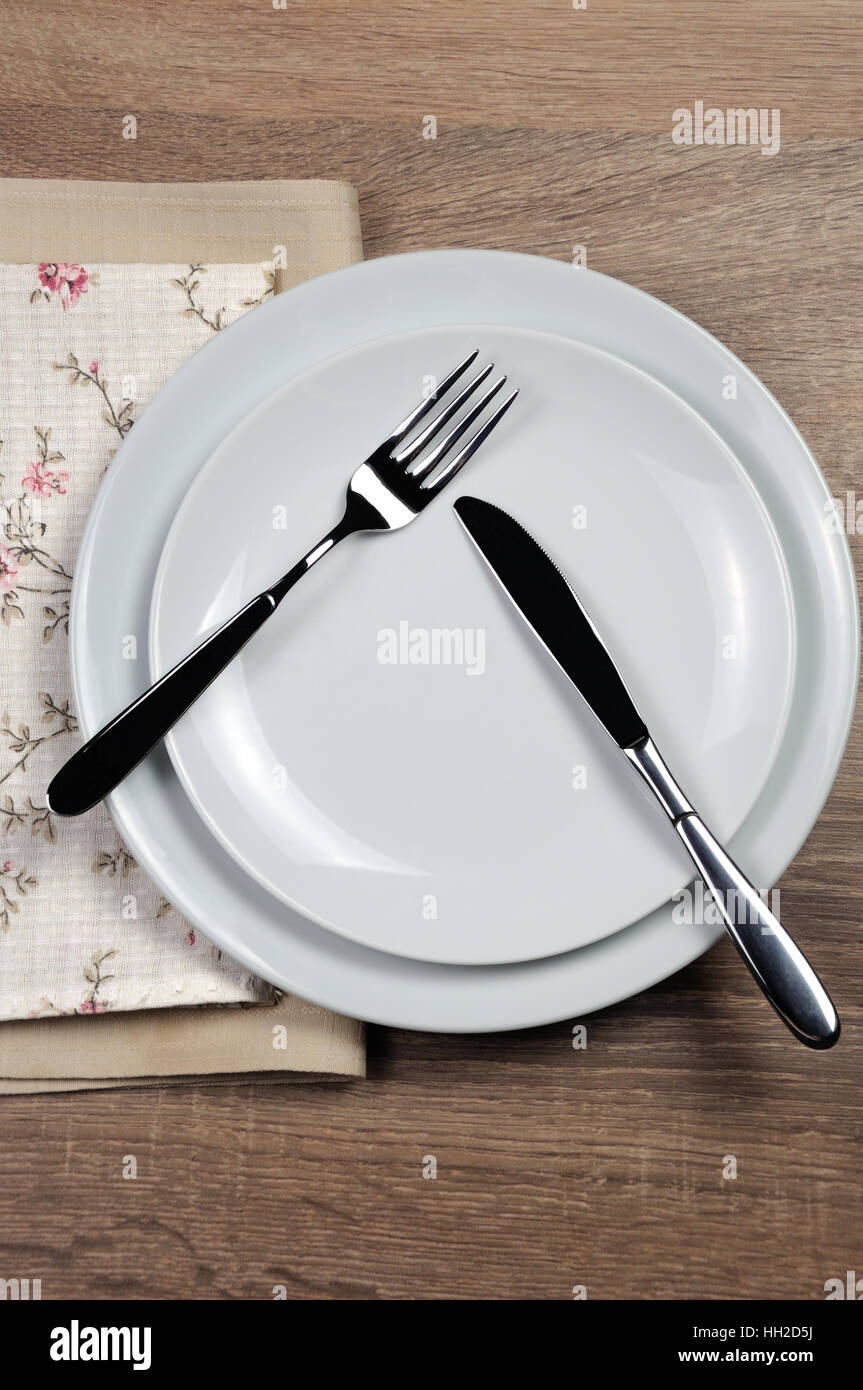 Dining etiquette - I still eat, pause. Fork and knife signals with location of cutlery set Stock Photo