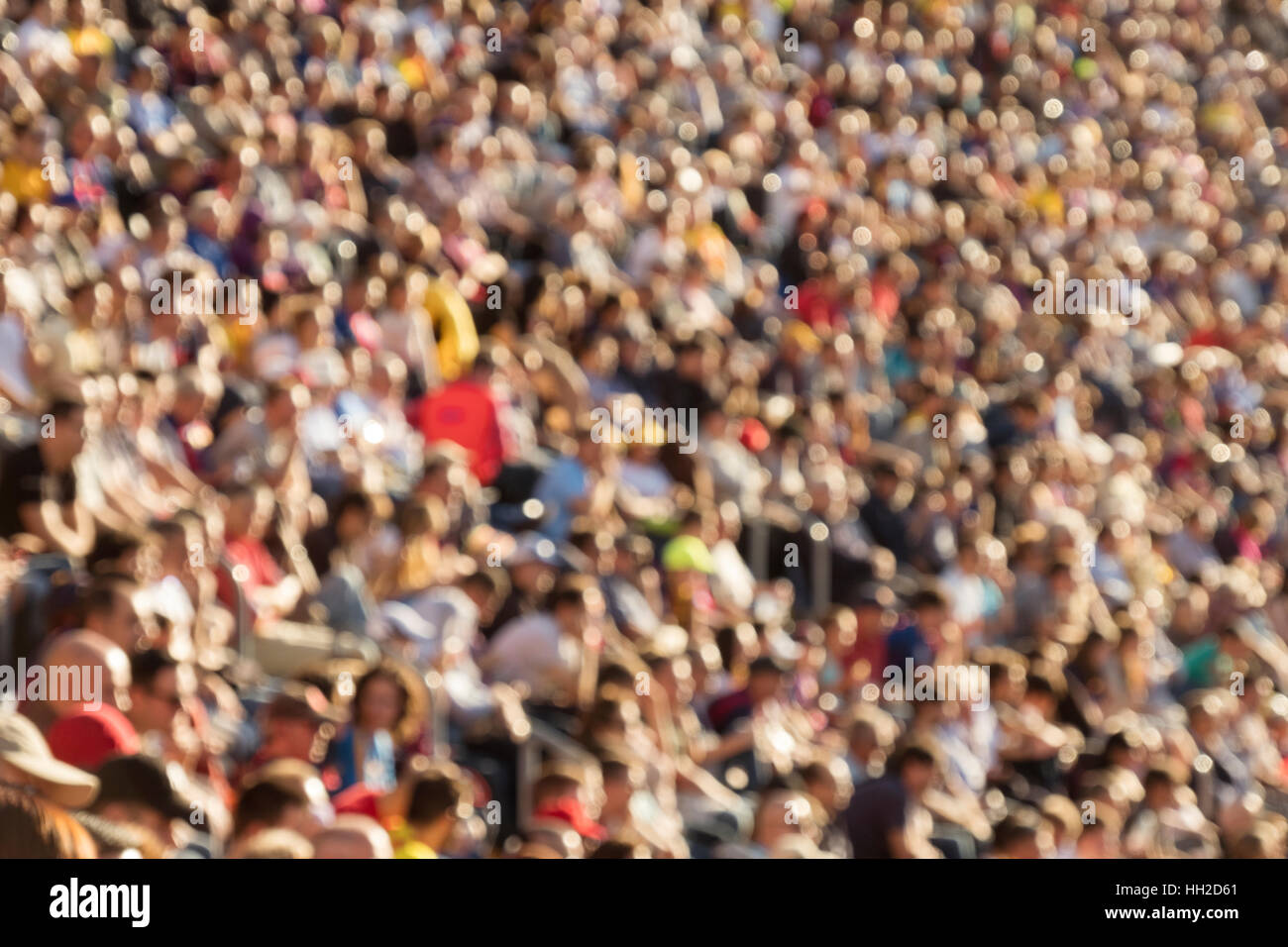 Blurred out people attending an event at an outdoor stadium Stock Photo