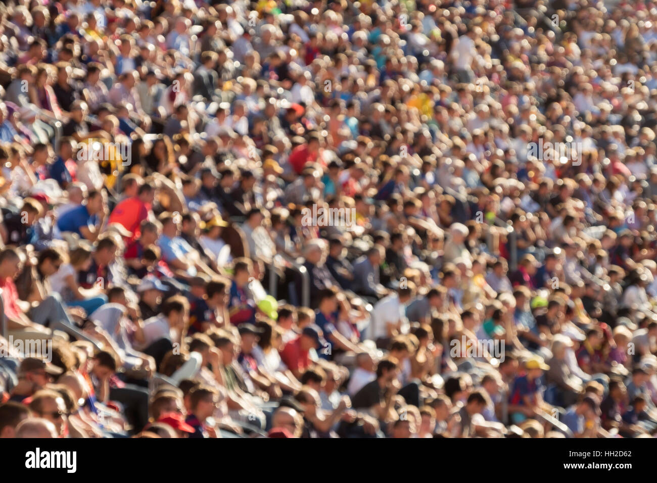 Blurred out people attending an event at an outdoor stadium Stock Photo