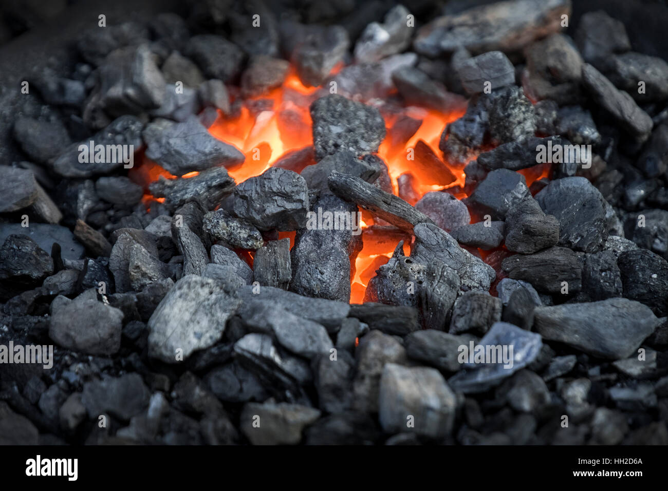 Blacksmiths coals burning for iron work Stock Photo