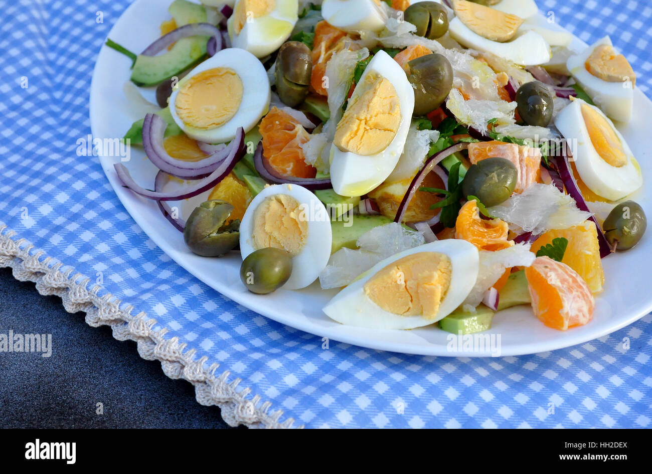 Salted tuna salad with avocado, orange, onion, hard boiled eggs, olives