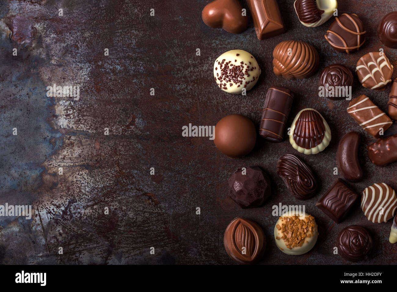 Assortment of fine chocolate candies, white, dark, and milk chocolate. Sweets background with copy space. Top view Stock Photo