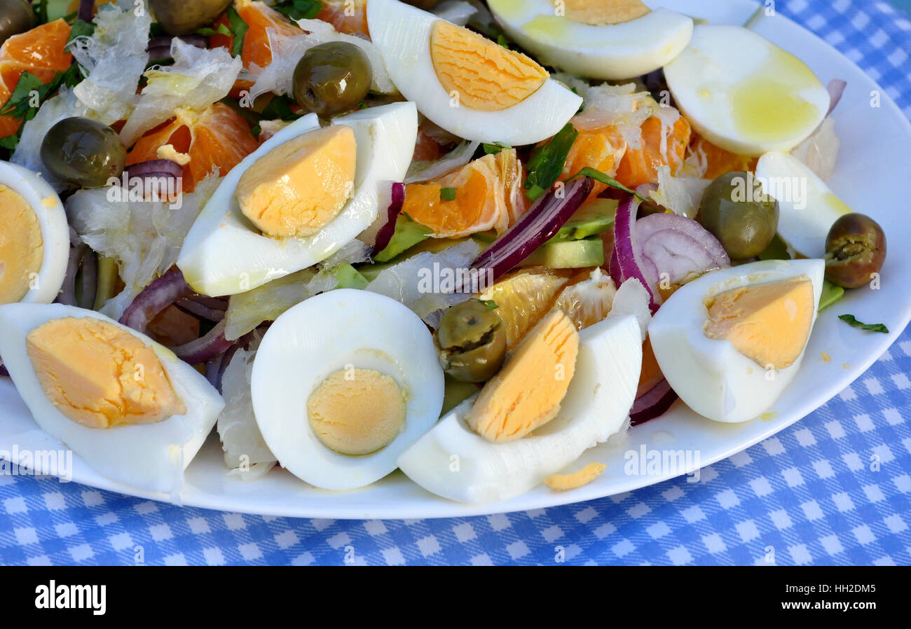 Salted tuna salad with avocado, orange, onion, hard boiled eggs, olives