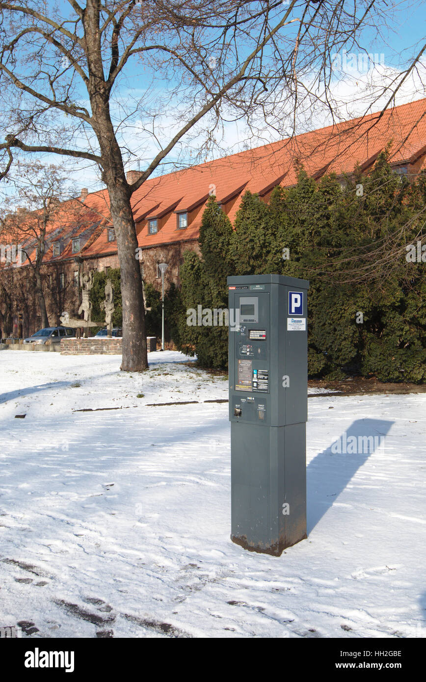 Parking meter in front of the museum of architecture in Wroclaw, Poland (former monastery) Stock Photo