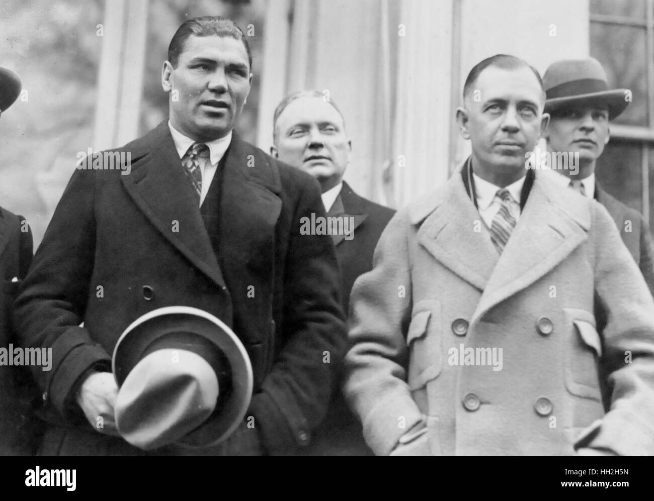 Boxing champ Jack Dempsey (left) and his manager, Jack Kearns (in light coat)  meet with the President today. Stock Photo
