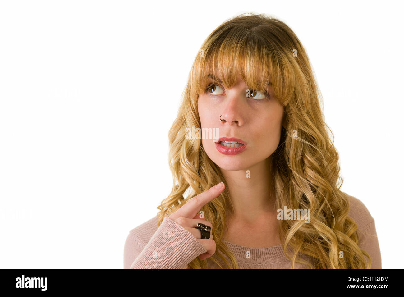 An attractive blonde woman pondering. copyspace for text. Stock Photo