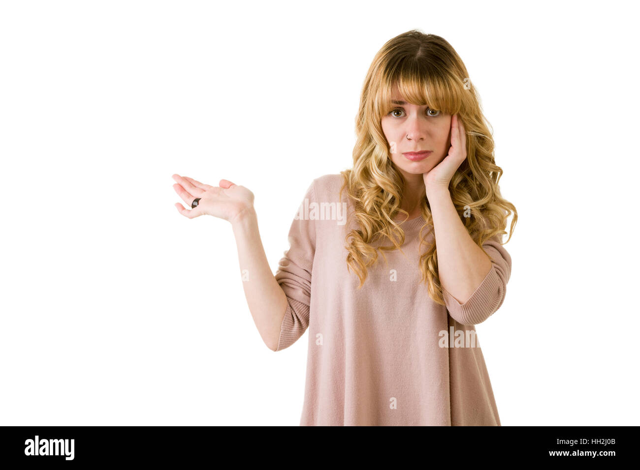 Worried blonde woman gesturing with arm. Stock Photo