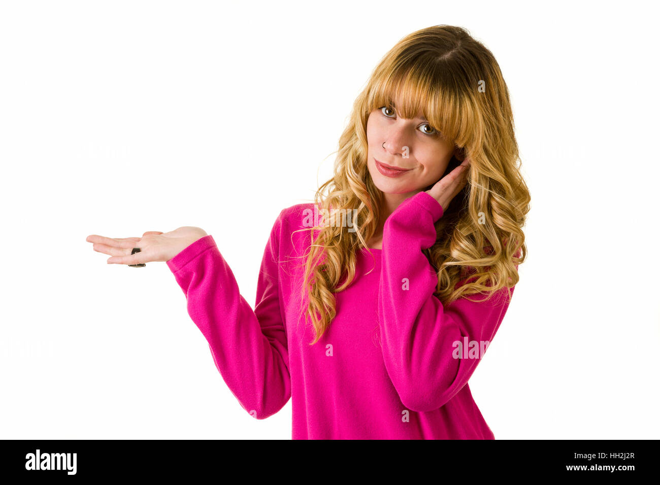 Smiling blonde woman gesturing with arm Stock Photo