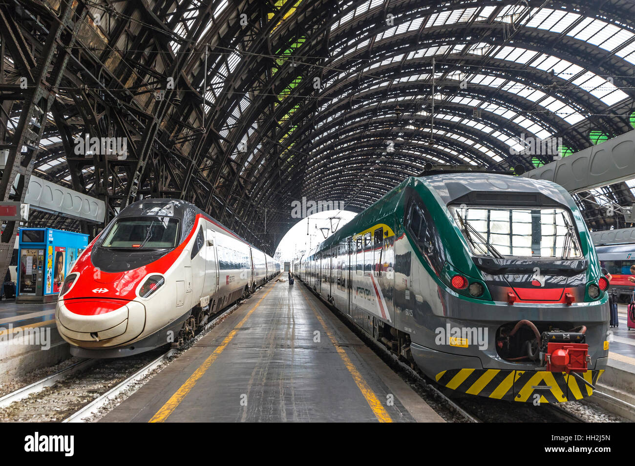 Train SBB (Left) and Trenord companies on platforms of the Milan Central Railway Station (Milano Centrale) Stock Photo