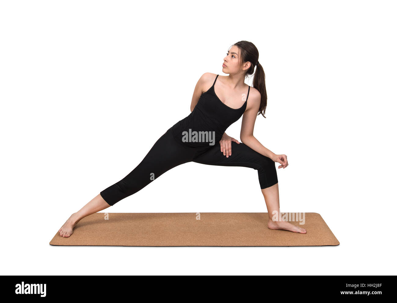 Young woman exercise yoga pose on cork yoga mat on white background Stock Photo