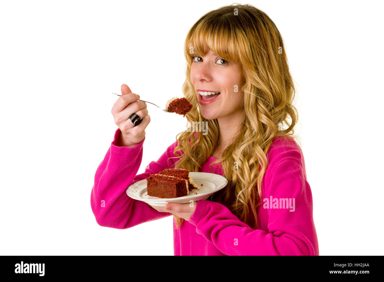 An attractive blonde woman enjoying a piece of cake Stock Photo