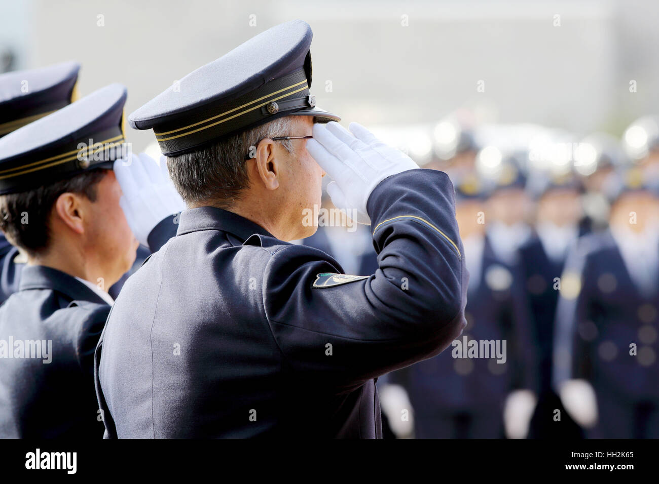Saluting Japanese police officers Stock Photo