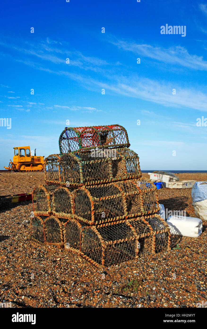 Crab pots stacked on the shingle beach at Cley next the Sea, Norfolk, England, United Kingdom. BHZ. Stock Photo