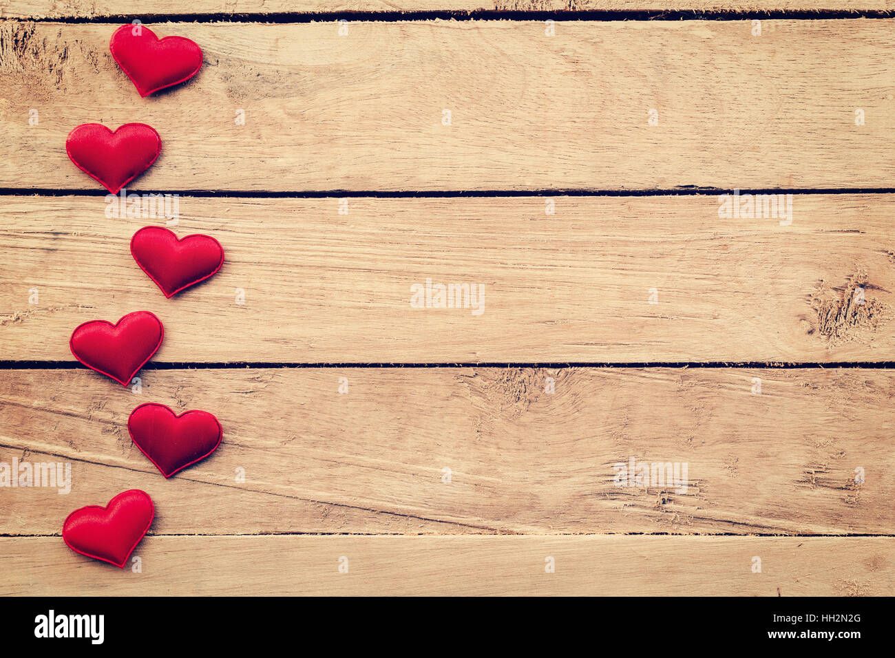 Red heart on wood background with space. vintage toned. Stock Photo