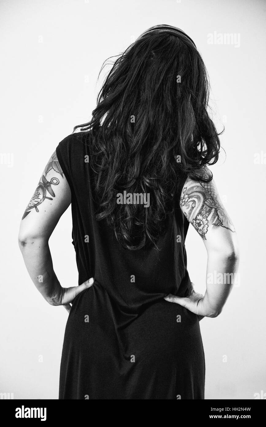 Black and white portrait of a woman with tattoos on arms Stock Photo