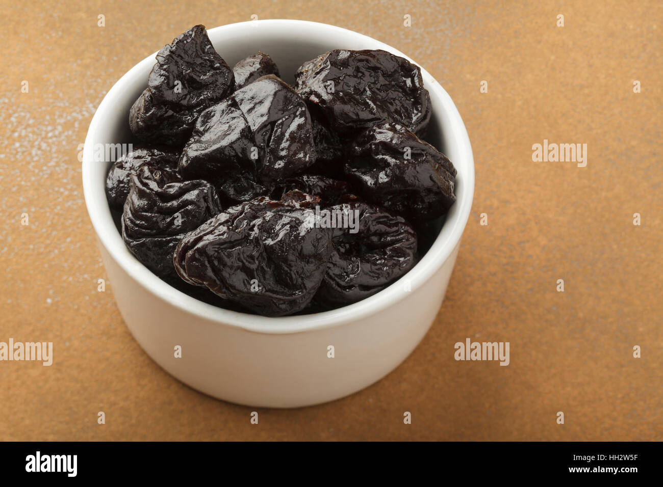 Prunes in White bowl Stock Photo