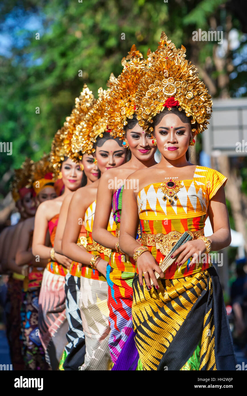 DENPASAR, BALI ISLAND, INDONESIA - JUNE 11, 2016: Group of Balinese people. dancer women in traditional costumes on festival Stock Photo