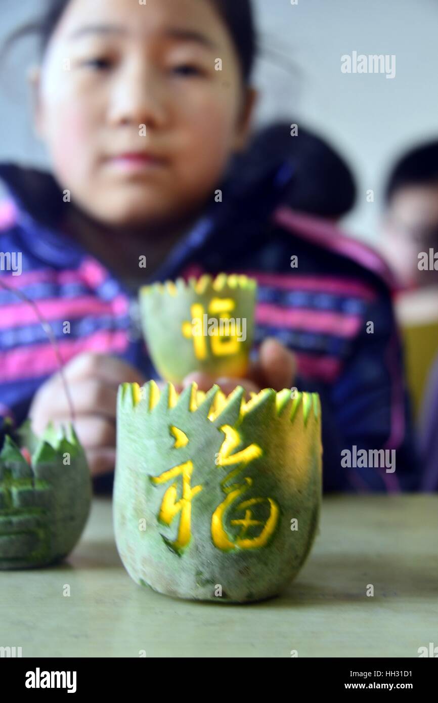 Liaocheng, China. 14th Jan, 2017. **EDITORIAL USE ONLY. CHINA OUT** Pupils show the turnip lanterns which they made under the guidance of students from Liaocheng University in Liaocheng, east China's Shandong Province, marking the upcoming Spring Festival and reviewing childhood memory. Credit: SIPA Asia/ZUMA Wire/Alamy Live News Stock Photo