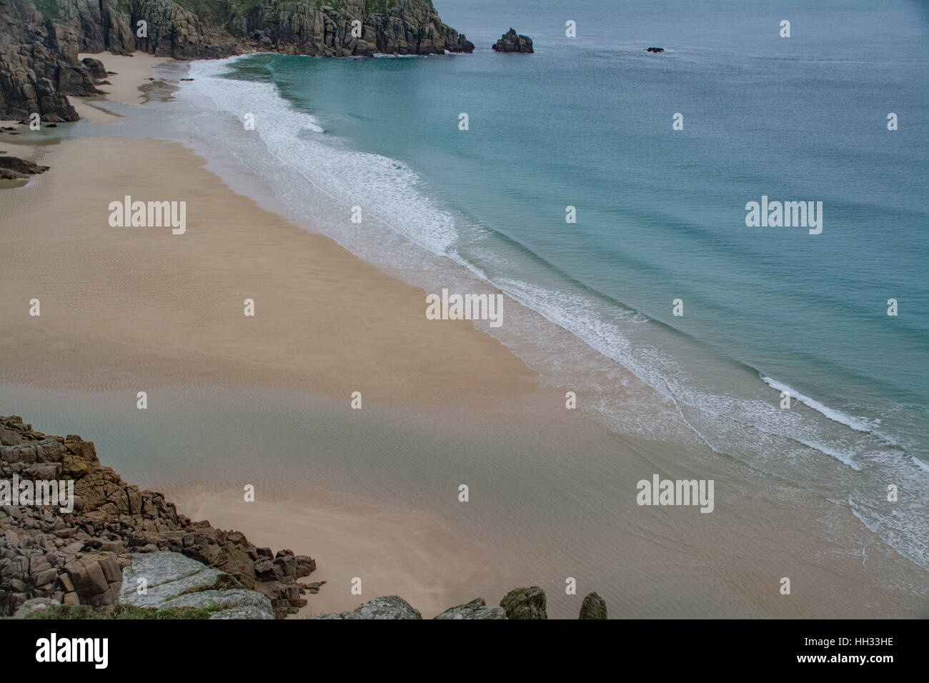 Treen, Cornwall, UK. 16th Jan, 2017. UK Weather. With temperatures of around 10 degrees C, and sheltered from the northerly wind, a sole swimmer makes the most of the blue lagoon formed on the beach at Treen on blue monday. Credit: cwallpix/Alamy Live News Stock Photo