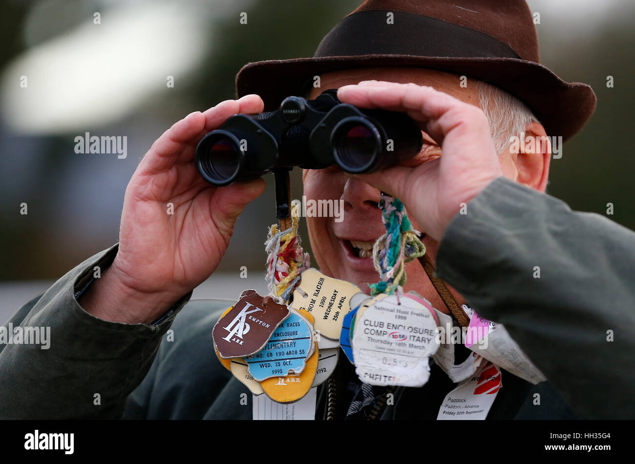 A punter watches the racing through a pair of binoculars at Plumpton Racecourse in Sussex, UK Stock Photo