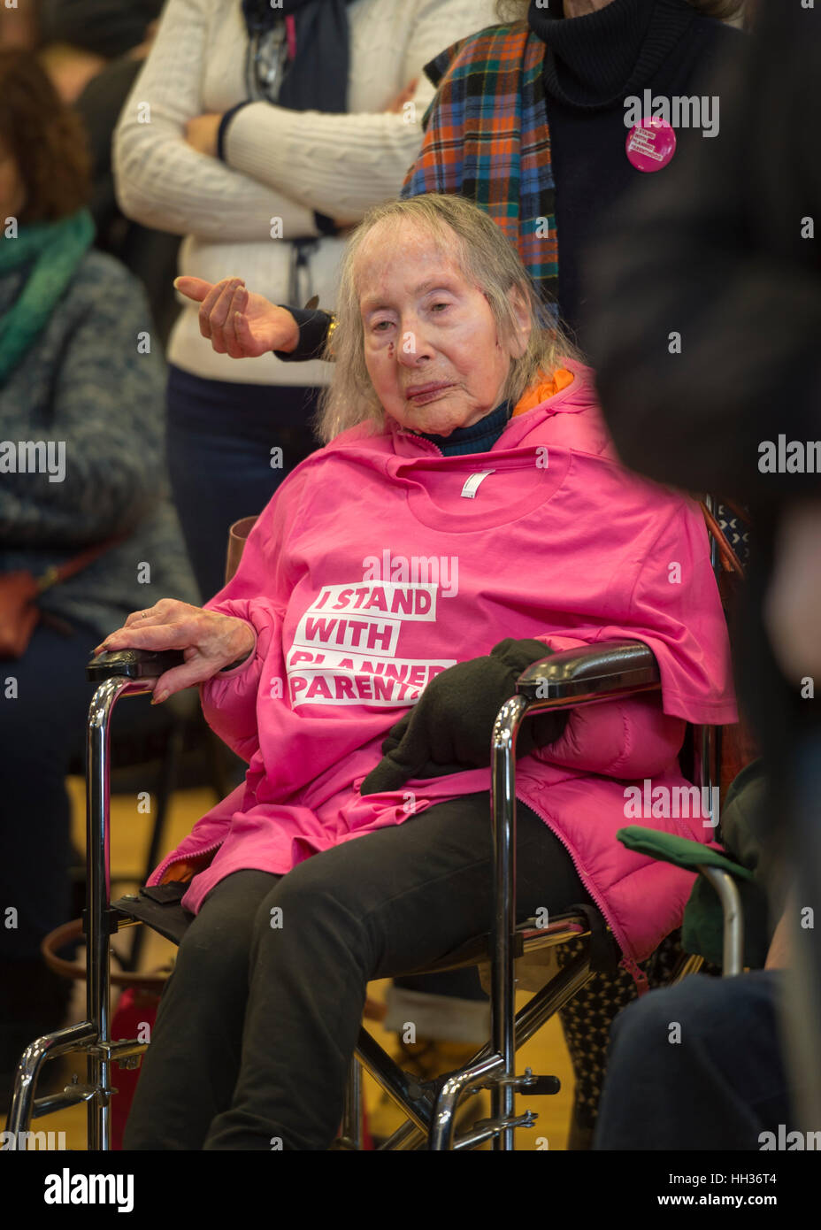 New York, USA. 15th Jan, 2017. In wheelchair, Pearl Berger, 97, of Amityville, who has breast cancer and Parkinson's Disease, has an "I STAND WITH PLANNED PARENTHOOD" pink shirt draped on her chest, at the "Our First Stand" Rally against Republicans repealing the Affordable Care Act, ACA, taking millions of people off health insurance, making massive cuts to Medicaid, and defunding Planned Parenthood. Credit: Ann E Parry/Alamy Live News Stock Photo