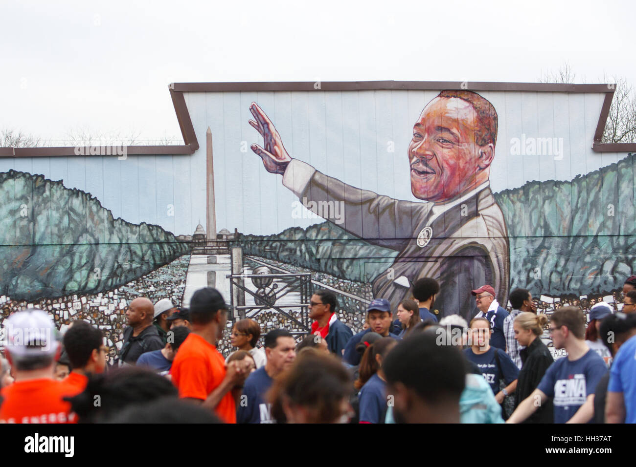 San Antonio, USA. 16th January, 2017. Marchers stand in front of a mural of Martin Luther King, Jr. before the annual Martin Luther King Jr. march in San Antonio, Texas. Several thousand people attended the city's 30th anniversary march celebrating U.S. civil rights leader Martin Luther King, Jr. Credit: Michael Silver/Alamy Live News Stock Photo