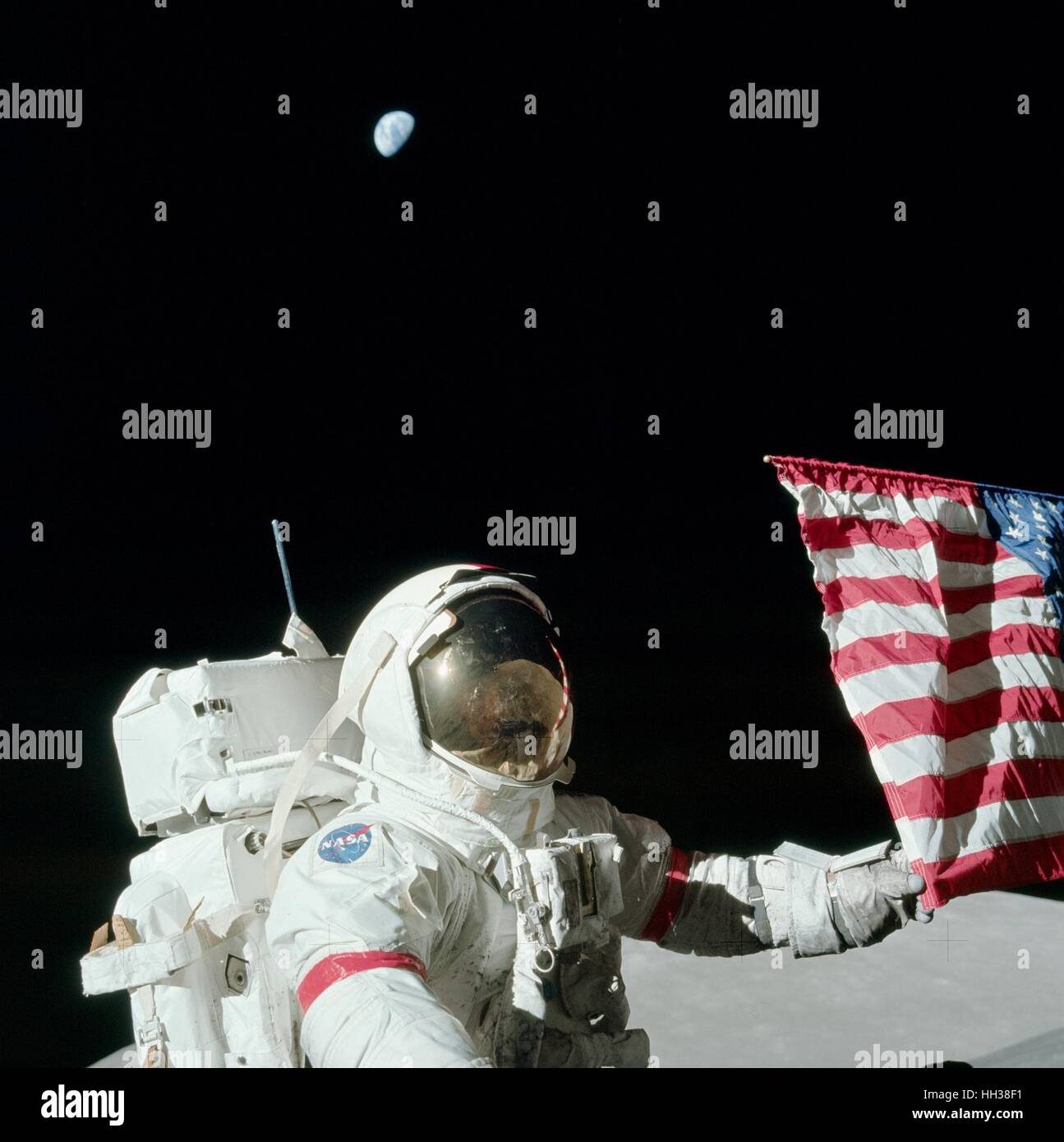 12th December, 1972. Apollo 17 commander Eugene A. Cernan is holding the lower corner of the American flag during the mission's first extravehicular activity (EVA). Photograph by Harrison J. 'Jack' Schmitt. This photo is part of the book 'Apollo: Through the Eyes of the Astronauts' published to commemorate the 40th anniversary of the first manned lunar landing on July 20, 1969. Credit: Harrison J. 'Jack' Schmitt - NASA via CNP /MediaPunch Stock Photo