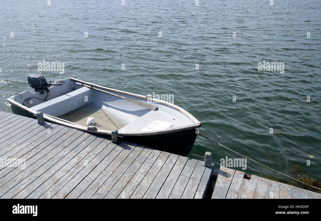 one rowboat tied to a wood pier Stock Photo - Alamy