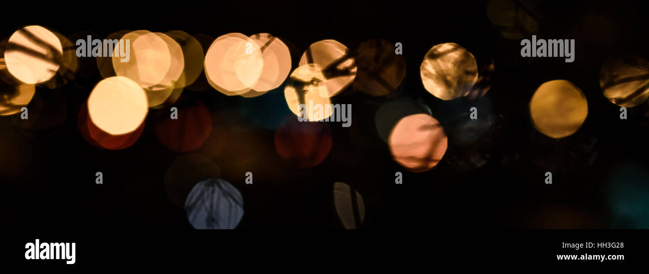 Golden bokeh in the blur on a dark Christmas background Stock Photo - Alamy