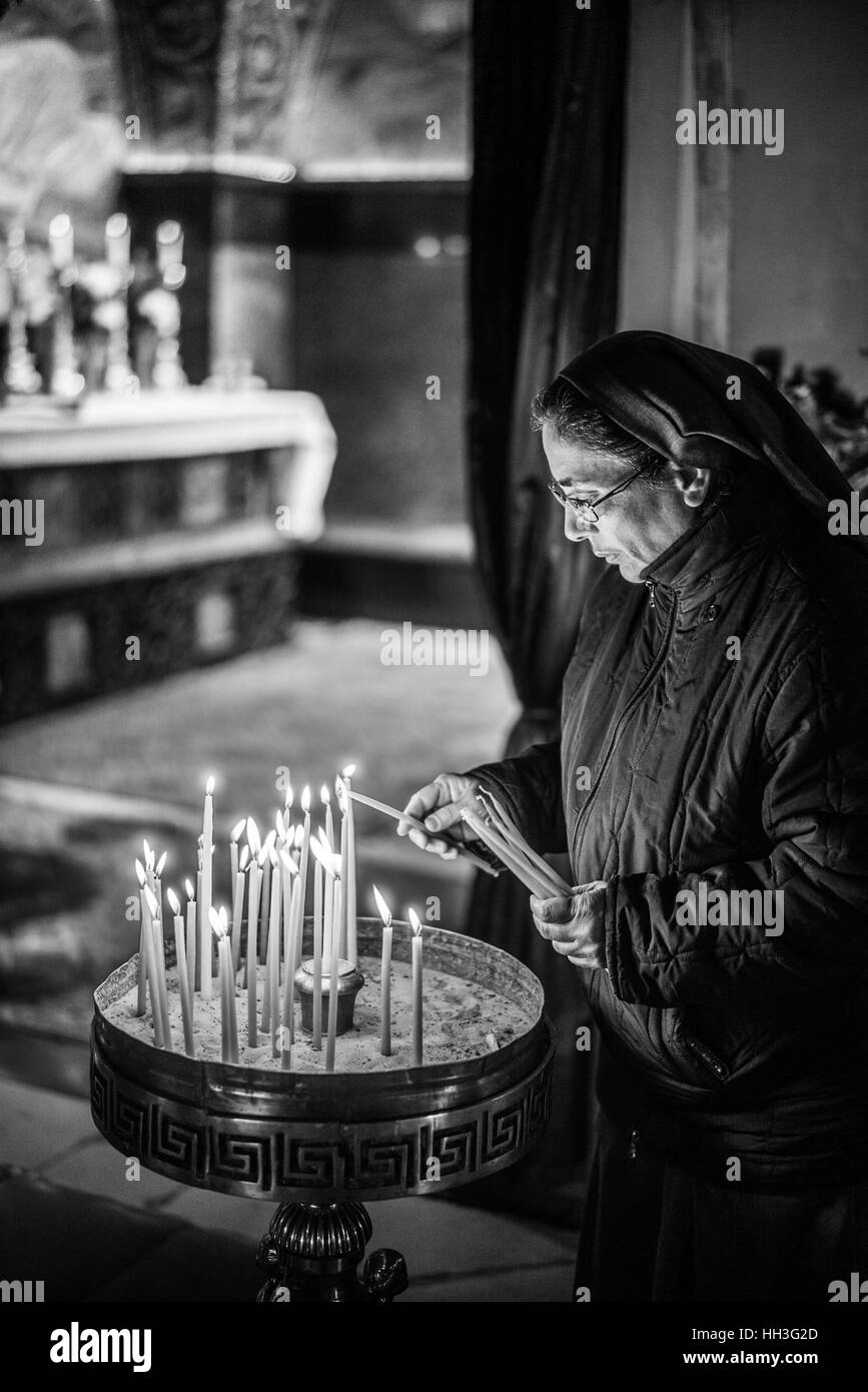 Pilgrims in the Crucifixion altar in the Church of Holy Sepulchre on Golgotha, Jerusalem, Israel Stock Photo