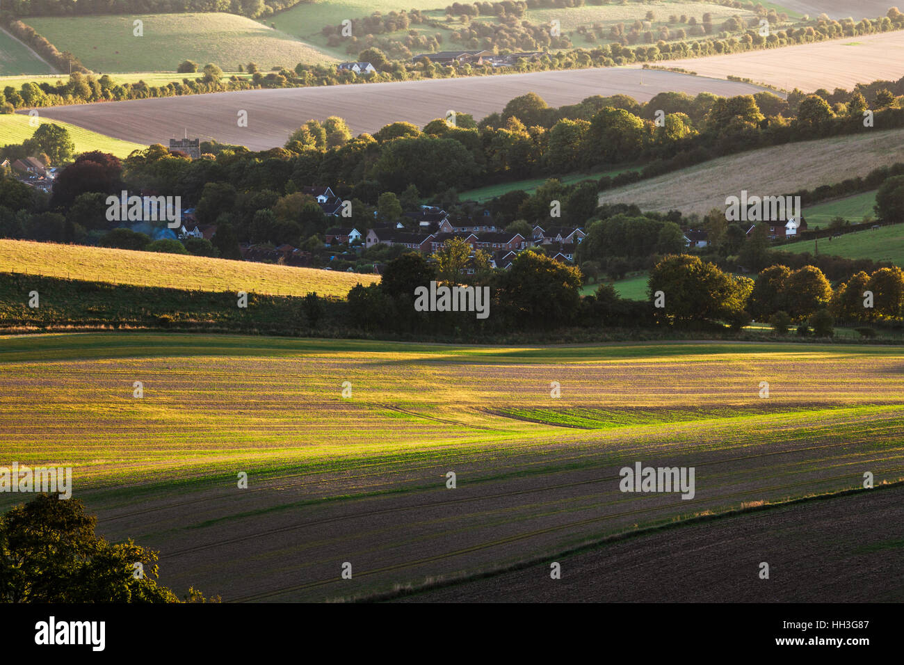 Sunset over the North Wessex Downs in Wiltshire looking over the village of Aldbourne. Stock Photo