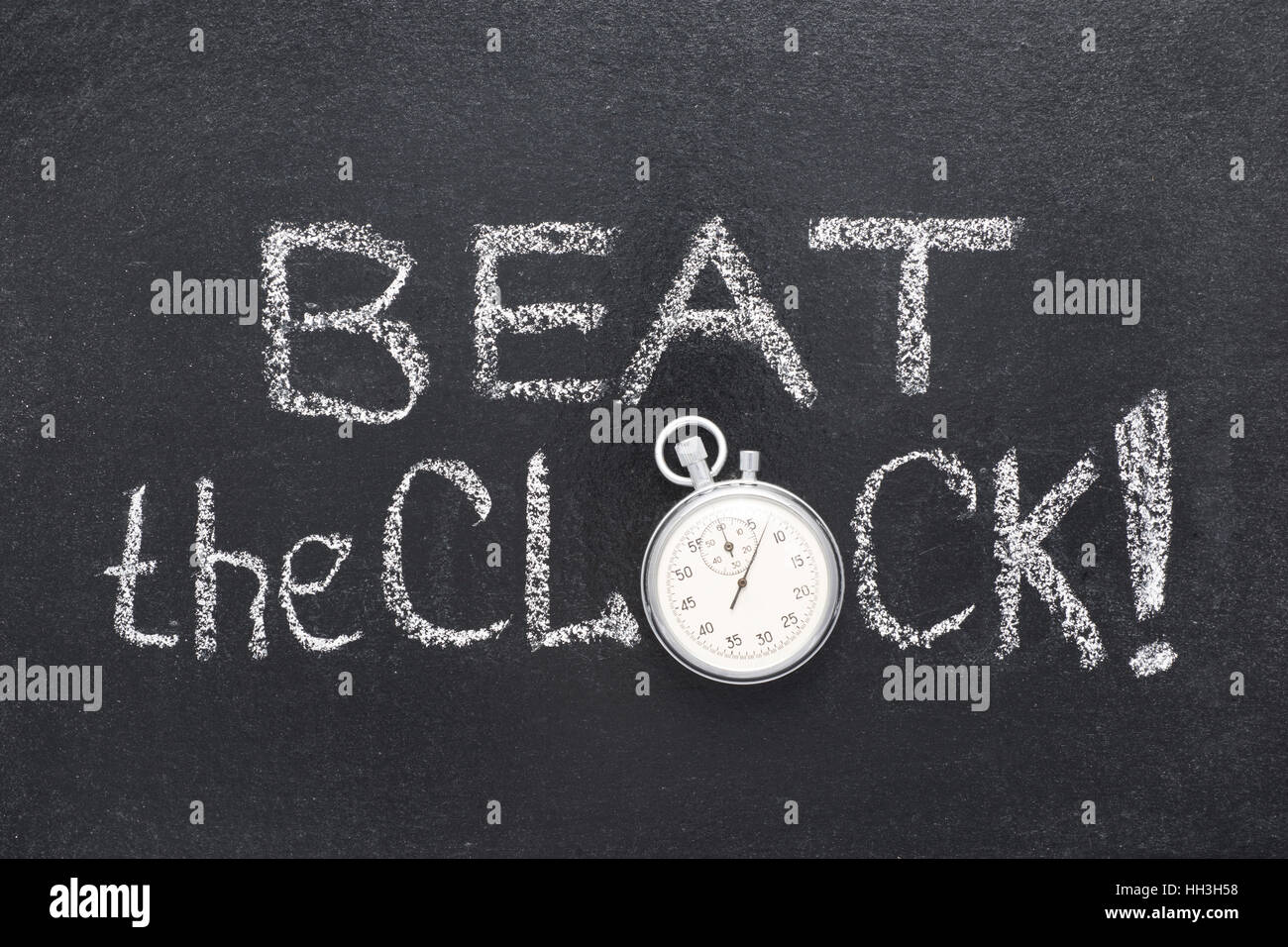 beat the clock watch phrase handwritten on chalkboard with vintage precise stopwatch used instead of O Stock Photo