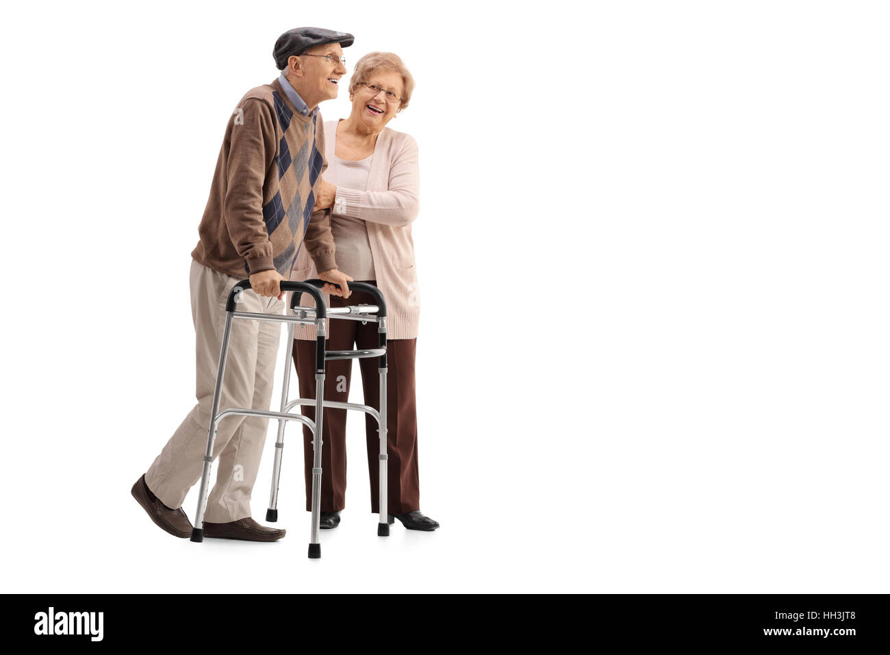 Full length portrait of a mature woman helping a mature man with a walker isolated on white background Stock Photo