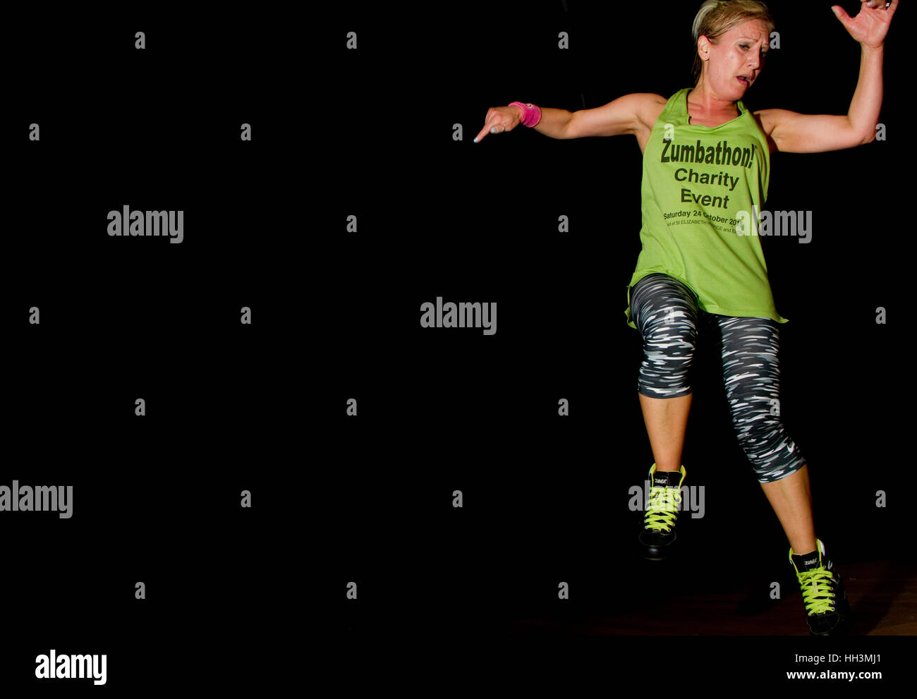 Woman in Zumbathon/keep fit clothes jumps in the air Stock Photo
